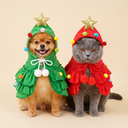 Dog and cat in matching green and red tree capes